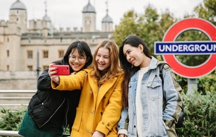 students clicking selfie at London Underground tube station