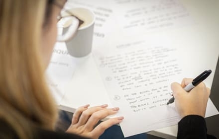 student writing on a paper