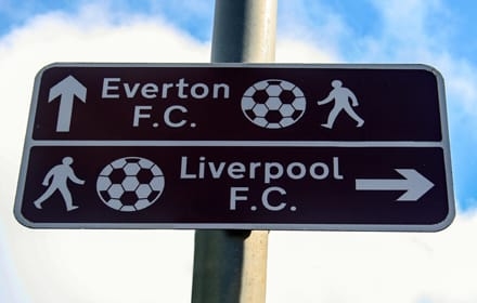 A sign explains the direction to Everton and Liverpool Football Club, England